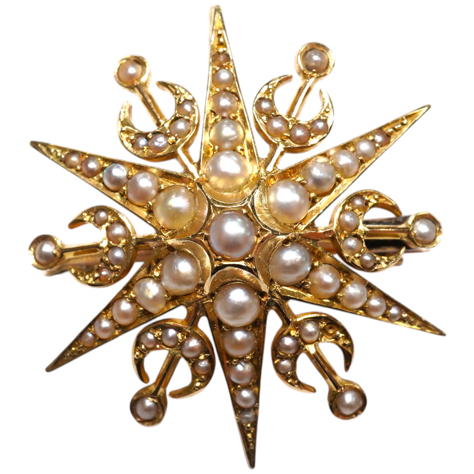 An Edwardian 15ct? and graduated seed pearl cluster set starburst pendant brooch, (lacking drop?), 30mm, gross weight 6.4 grams. Condition - fair